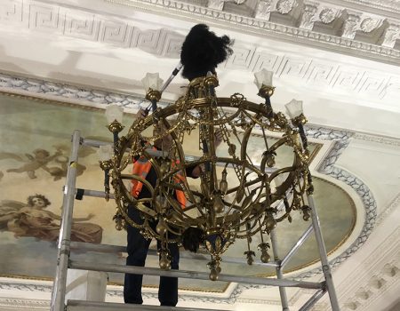 Electrical Services, An Electrician installing a chandelier in a Ballroom.