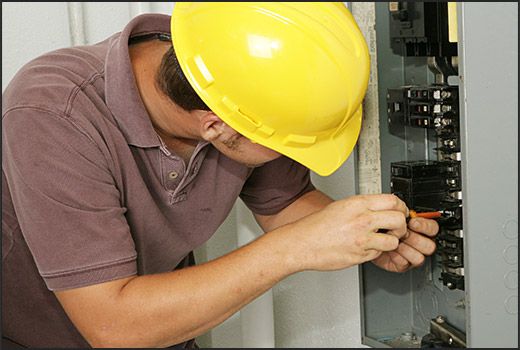 Electrical Service, An Electrician installing circuits in an electrical panel
