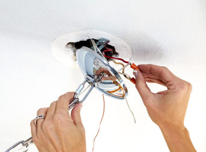 Electrical Service, An Electrician installing a ceiling light